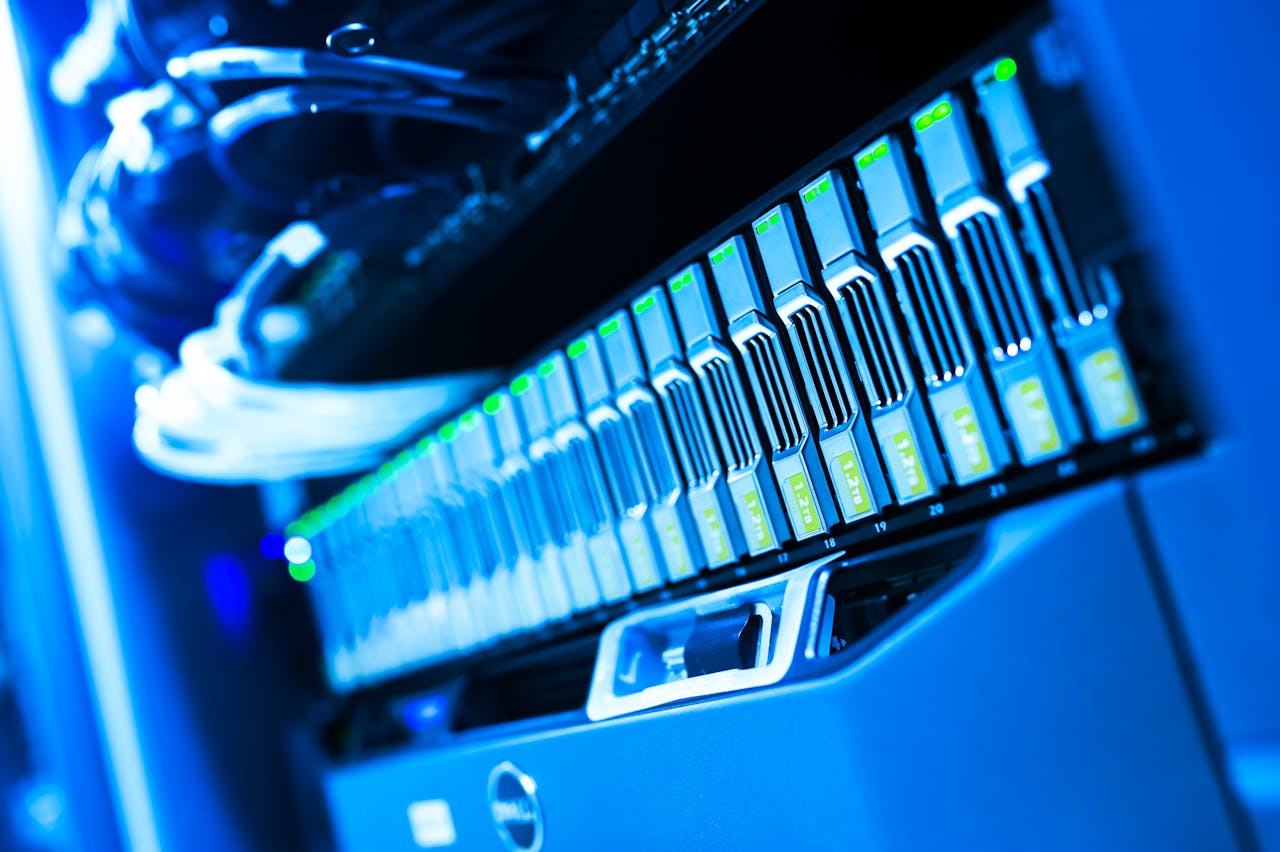Services-02 A detailed view of a blue lit computer server rack in a data center showcasing technology and hardware.